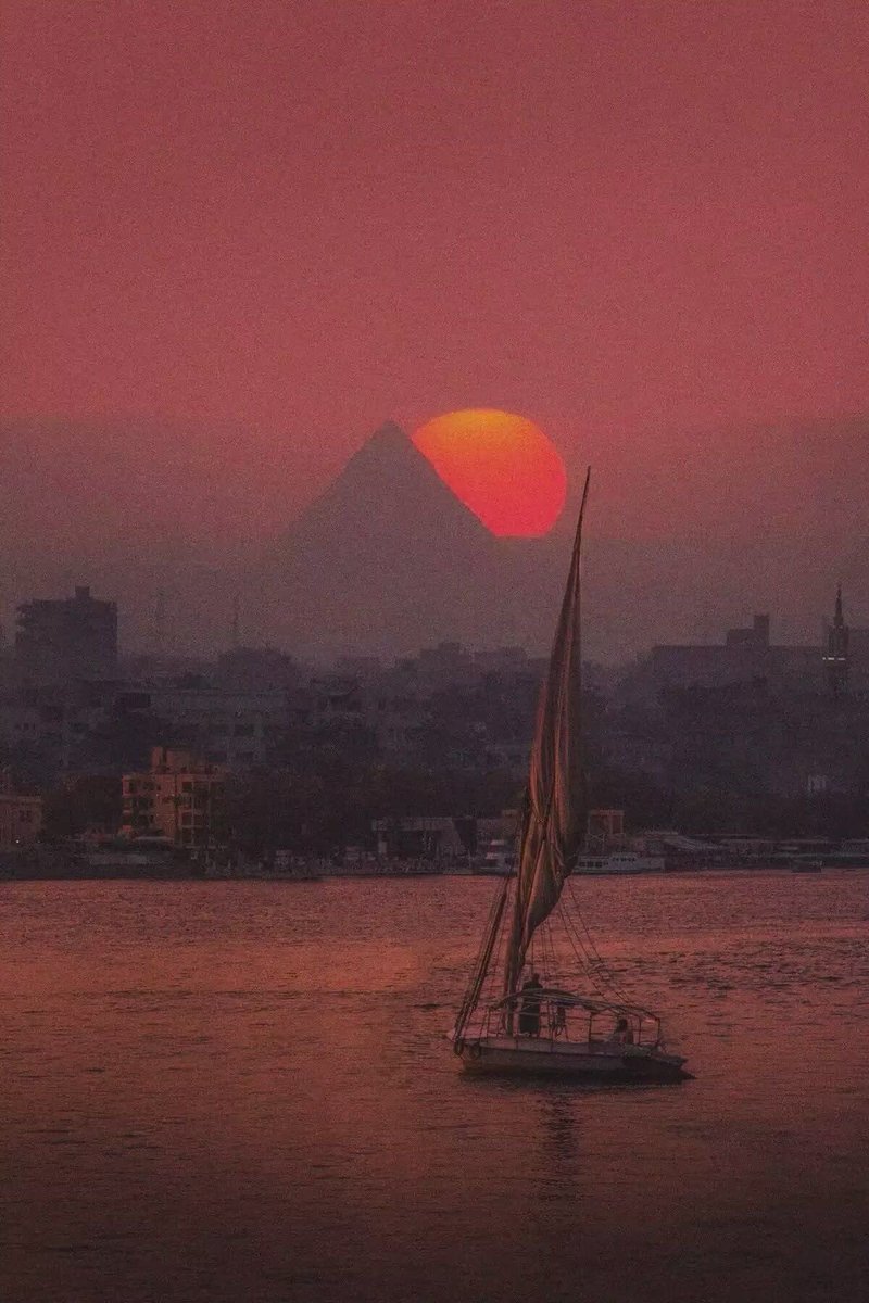 "Where the timeless Nile flows under the golden sun, the majestic Pyramids stand as eternal guardians of history — Egypt's beauty in one breathtaking view."