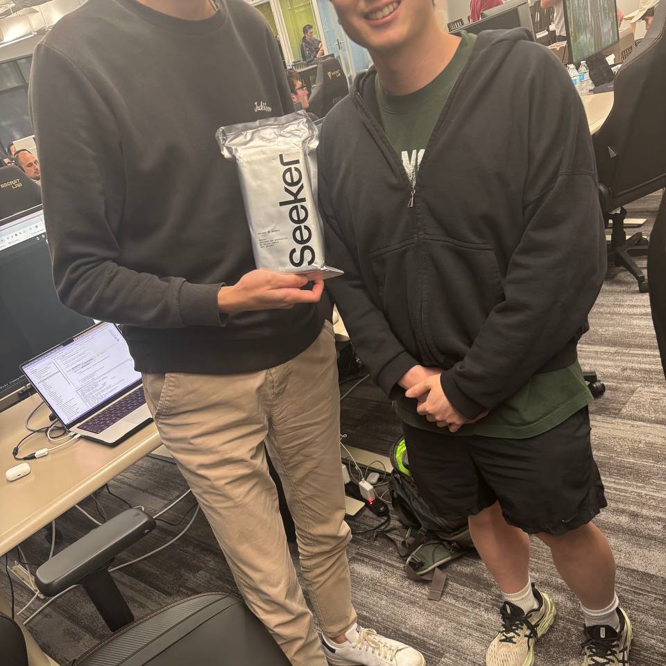 Solana developer Odo holding the Seeker phone package in an office setting