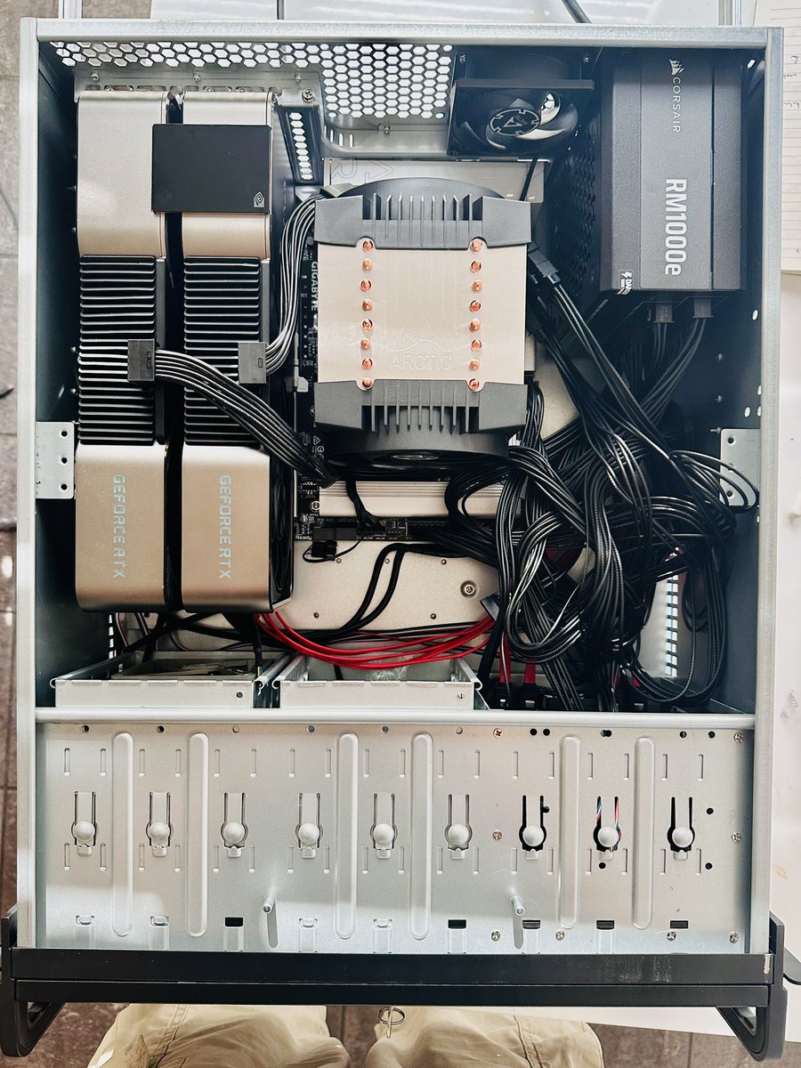 Still need to do some cable management and it remains to be seen whether that PSU will be adequate, but it posted. 

24 Zen4 cores
128GB DDR5 5600 RDIMM
2x RTX 3090 TI 24GB w/ NVL

And don’t worry those GPUs are power limited to 250W. The PSU shouldn’t explode.