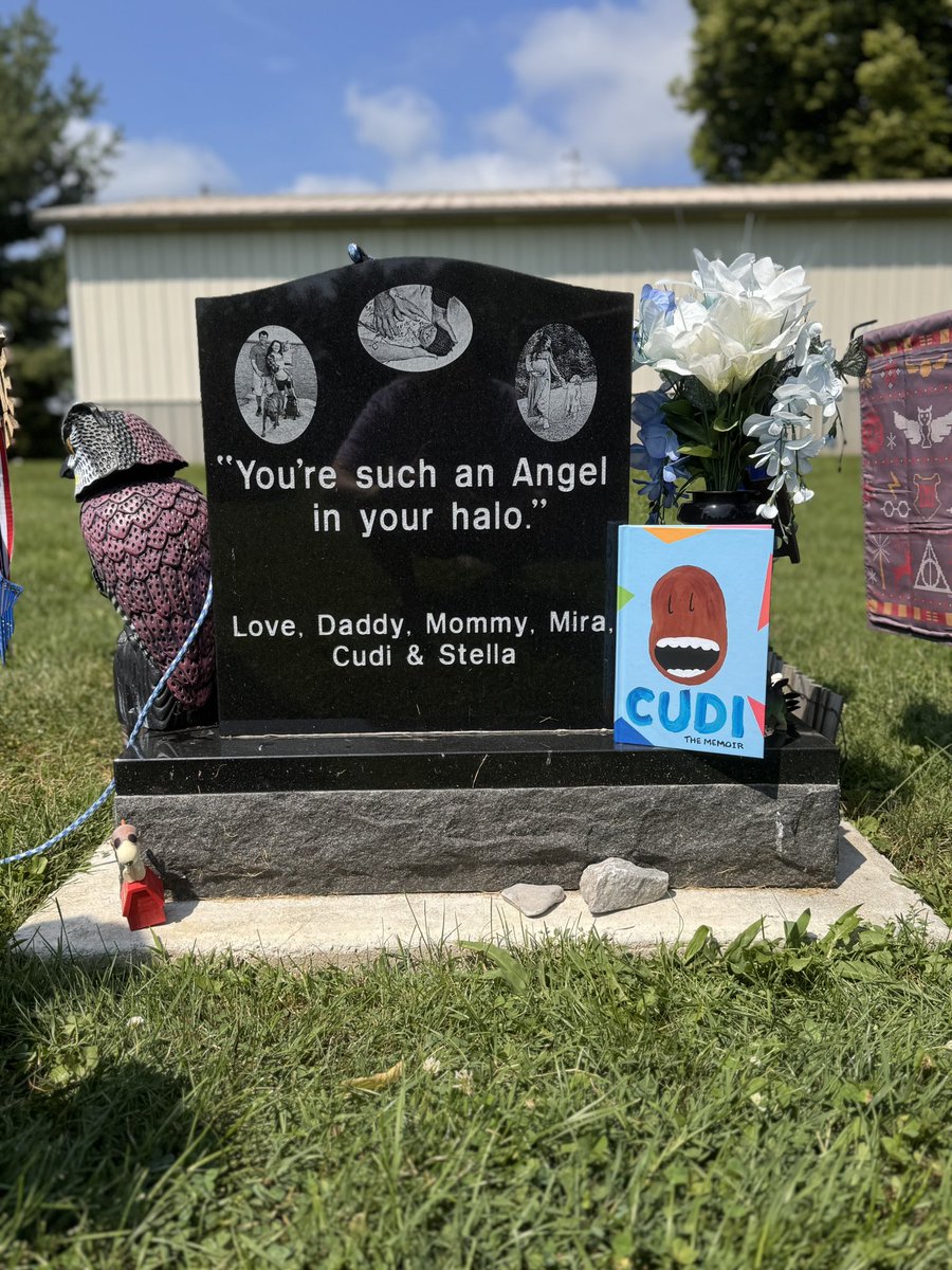 _lexis_'s tweet photo. he just finished Cudi: The Memoir today, reading next to Malaki. the song we played in our last moments with him before we had to say our see you laters on his headstone. @KiDCuDi and his music have helped not only him, but so many other people. thank you for saving mine. 🤍 https://t.co/uYiO6GMtZA