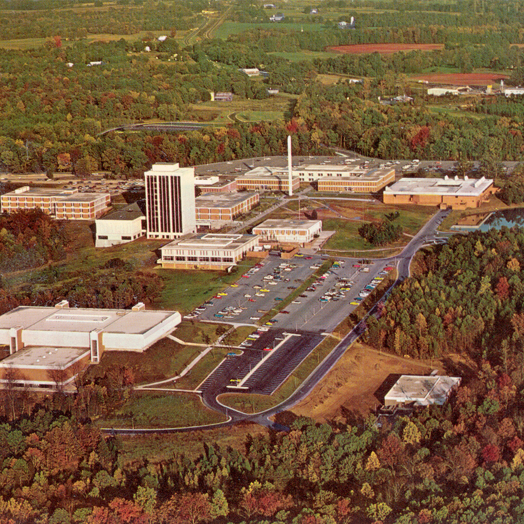 #ThrowbackThursday You know the drill! Take a good look and drop your best guess for what year this aerial campus photo was taken! 👀

Check out the parking lot—apparently yellow, red, and turquoise were the car colors of the moment. 🚗