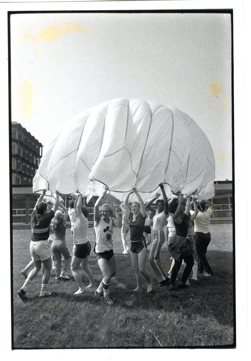 #ThrowbackThursday P.E. students playing with a parachute on campus, circa 1970s