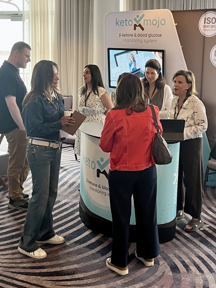 Attendees at the <a href="/KetoMojo/">Keto-Mojo</a> booth on Day 1 of the 10th Annual San Diego Symposium for Metabolic Health.

Keto-Mojo has been a longtime sponsor of the Symposiums and is a valued member of the low-carb/ketogenic community.
