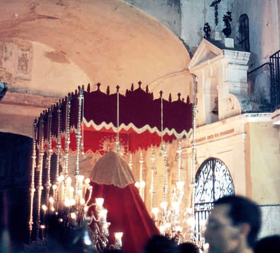 Curiosa imagen del palio de la Virgen del Buen Fin pasando ante la Capilla de la Pura y Limpia del Postigo en la noche del Miércoles Santo de 1980, cuando La Lanzada procesionó en segunda posición, volviendo por el Arenal a modo de prueba.