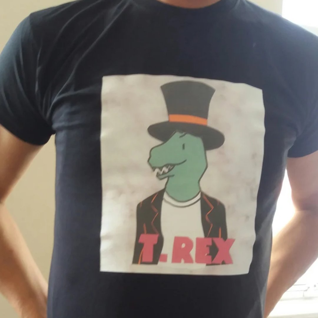 AxelinaPro's tweet photo. Who likes this cool T Rex T-shirt? It is available in both kids and adult sizes at my Etsy shop at https://t.co/kCpDi20JlJ #Trex #UkMakershour #shopindie #marcbolan #theslider #tyrannosaurusrex #craftbizparty #handmadehour https://t.co/0el7CEE0qE