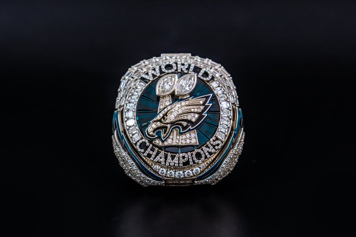 ProFootballHOF's tweet photo. It all starts with 145 diamonds, marking the record points scored in the postseason by the Eagles. Forty more form ‘WORLD CHAMPIONS,’ honoring their 40-point Super Bowl LIX win. Eighteen midnight-green sapphires represent 18 total wins. Hidden wings open to reveal a message: You can’t be great without the greatness of others. See the ring for yourself, now on display at the Hall of Fame!