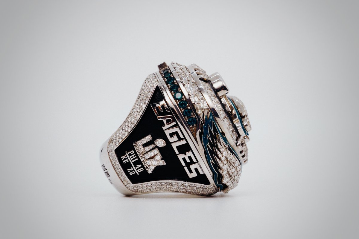 ProFootballHOF's tweet photo. It all starts with 145 diamonds, marking the record points scored in the postseason by the Eagles. Forty more form ‘WORLD CHAMPIONS,’ honoring their 40-point Super Bowl LIX win. Eighteen midnight-green sapphires represent 18 total wins. Hidden wings open to reveal a message: You can’t be great without the greatness of others. See the ring for yourself, now on display at the Hall of Fame!