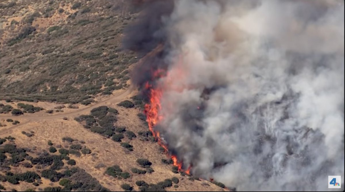 CAWildfiretrack's tweet image. Some images from the NBCLA live stream. Hand crews are going to work on the left flank, the fire has slopped over the ridge and is threatening a radio tower. #HawkFire