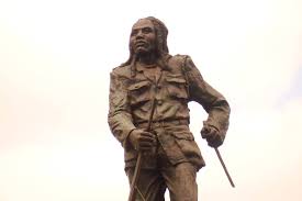 Assassination Tape 8 — Dedan Kimathi (1957, Kenya)

The forest general who made the empire tremble.
February 18, 1957 — Dedan Kimathi was hanged by the British colonial government.
They buried him in an unmarked grave.
But his ghost still walks in the Mau Hills.