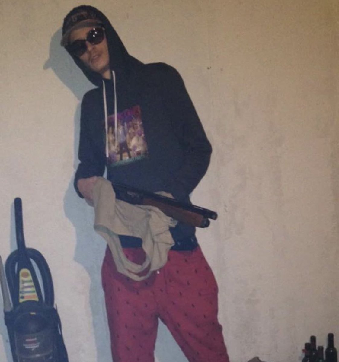 Dj Smokey brandishing a weapon while standing beside a vacuum in 2013 #rare