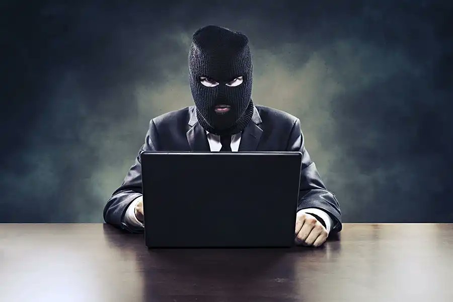 Illustration of a hacker at work, representing cyber threats in crypto