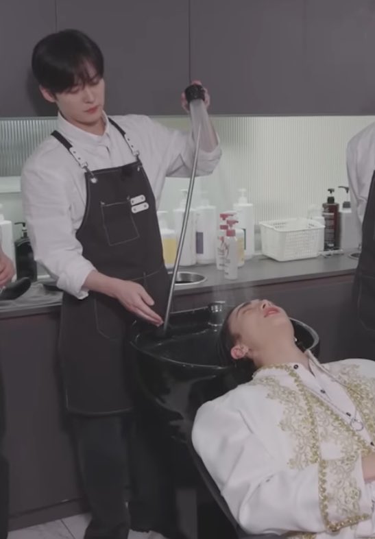 He is just watering a pretty flower, this explains the pose -