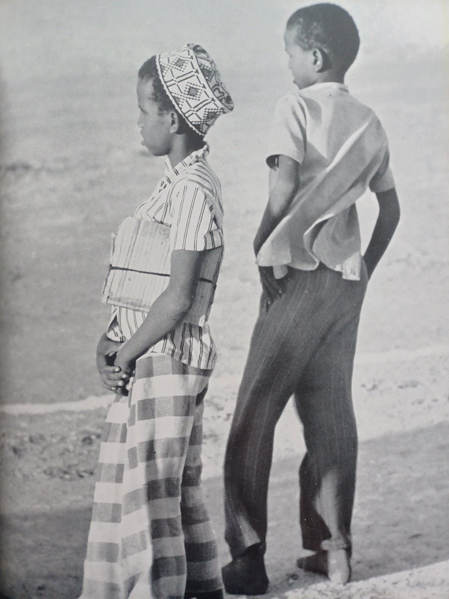 thesomaliarchiv's tweet photo. A pair of schoolboys onlooking in 1960. https://t.co/3DJjfT8q4N