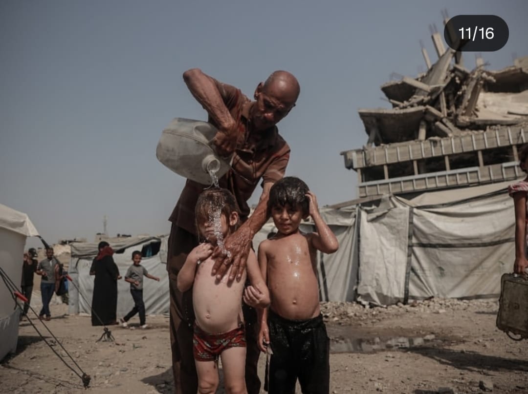 MJabaara's tweet photo. A heatwave with unbearable temperatures is sweeping the country but imagine those living in worn-out tents, with little food and  no proper shelter
Here in Gaza, children try to escape the burning sun by playing with water  a small attempt to ease an unbearable heat. https://t.co/DXo65HGjfq