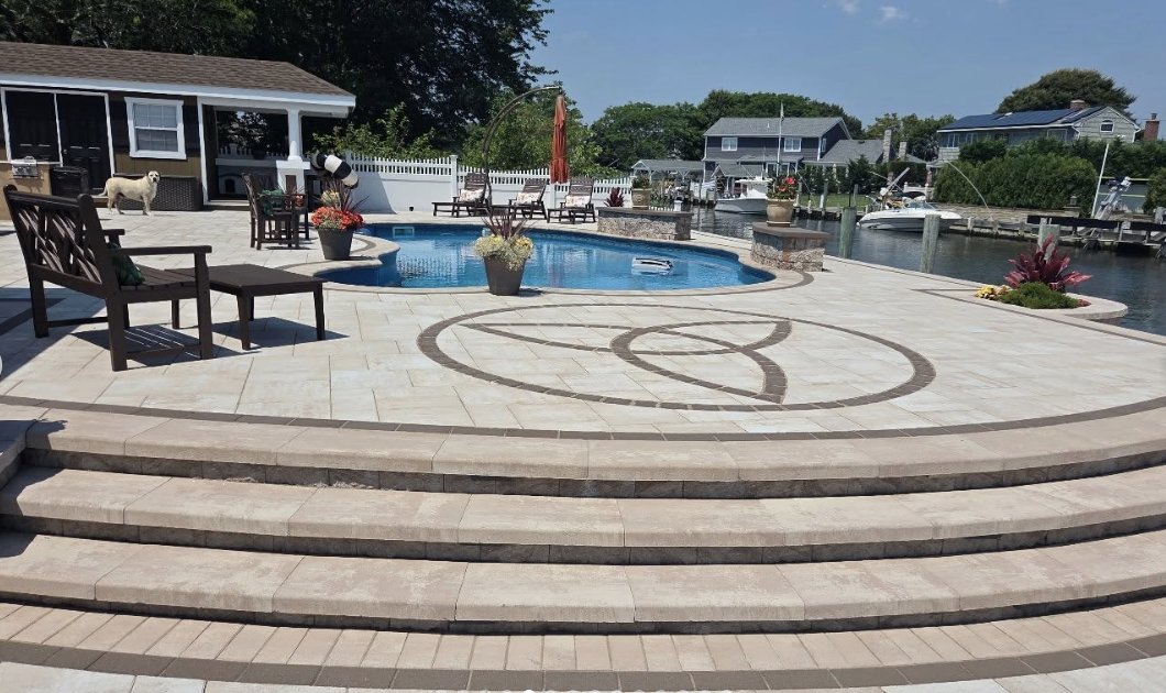 ✨ Waterfront luxury, handcrafted to perfection.

This breathtaking backyard escape by Royal Stone and Masonry features Cambridge Pavers in a soft neutral blend, curved steps, and a striking custom inlay that adds timeless elegance. 

#CambridgePavers