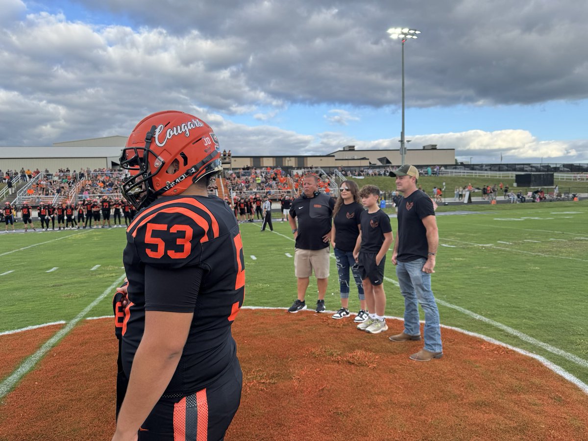 Touching moment before North Daviess game. Cougars honored their late teammate JD Moore who was killed in a car accident in February. ND captains carried Moore’s #8 jersey out for coin toss with Moore family joining them at midfield.