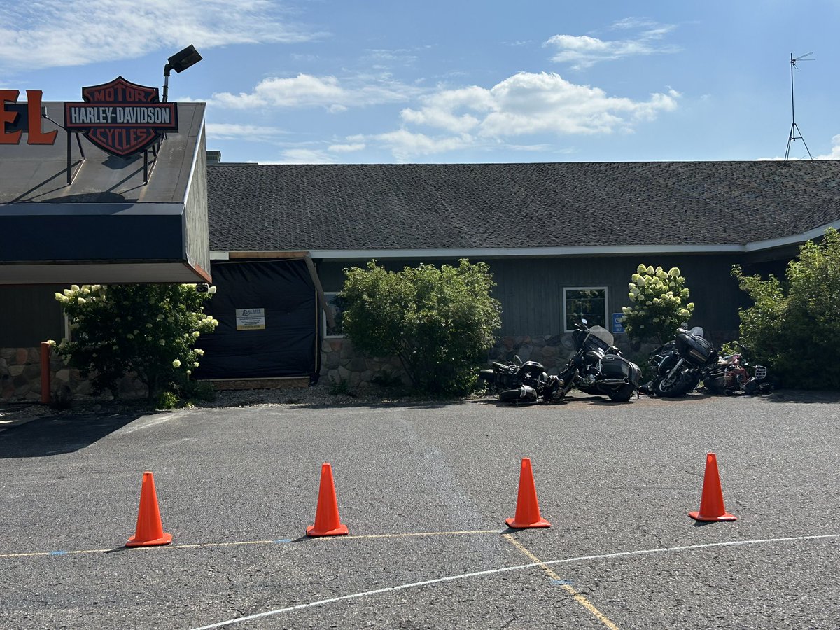 mgoblue85's tweet photo. Apparently, someone took a trip through Zips on Monday. The black tarp covers the impact location. Thankfully it was after they closed for the day. The owner says the vehicle was going over 60mph when it hit the building. Yikes 😬 #GaylordMichigan #45thParallel #HarleyDavidson https://t.co/0eDqFLKVBD