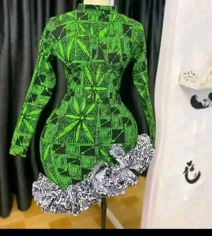 Vibrant green floral-patterned dress with a modern twist, featuring a ruffled hem and fitted silhouette.🥰