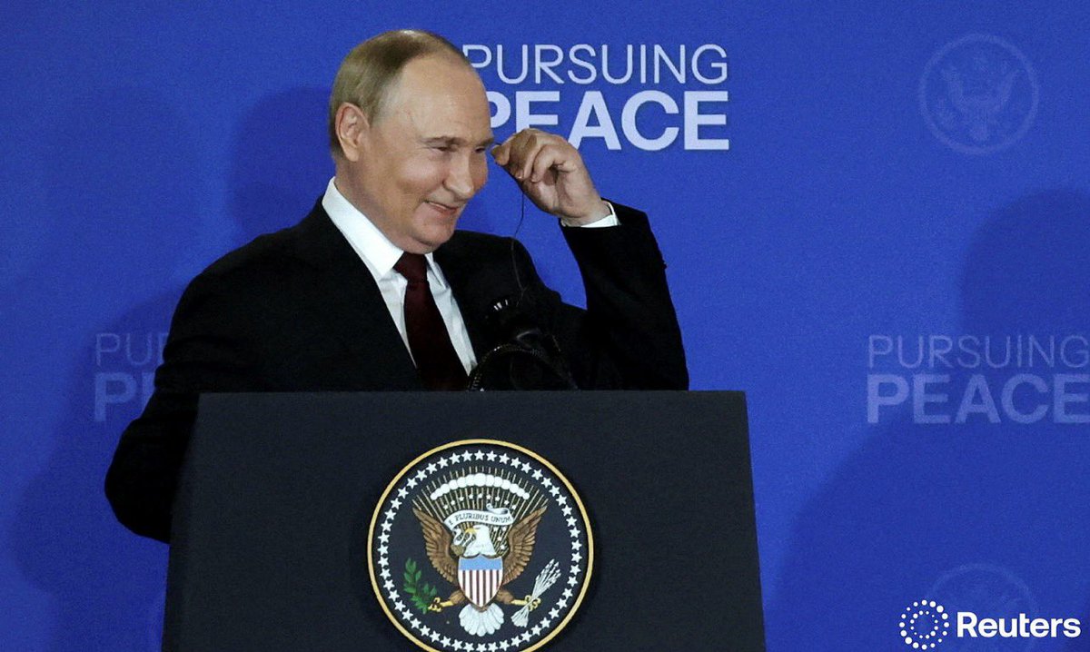 Russian President Vladimir Putin reacts as he holds a press conference with U.S. President Donald Trump following their meeting to negotiate an end to the war in Ukraine, at Joint Base Elmendorf-Richardson in Anchorage, Alaska, U.S., August 15, 2025. REUTERS/Jeenah Moon