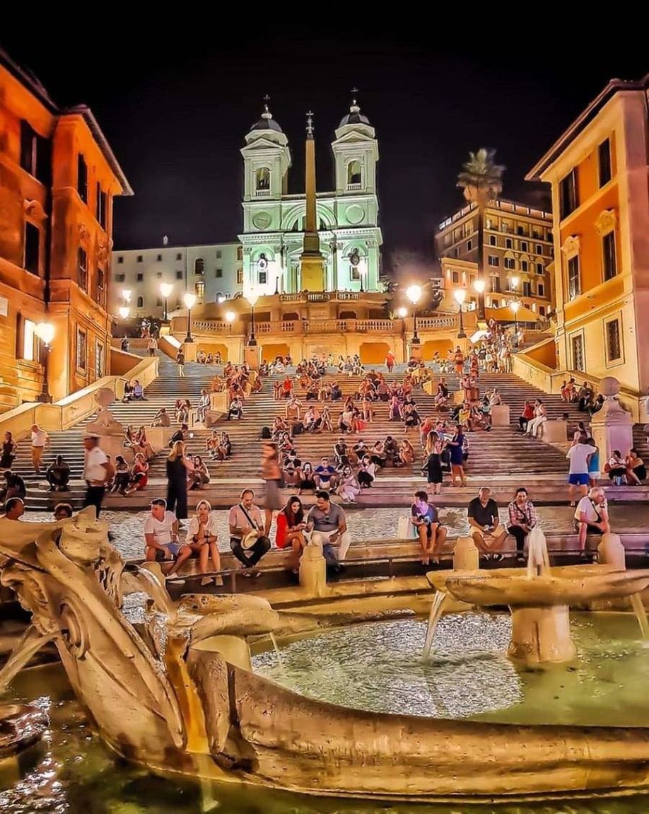 The Spanish Steps in Rome come alive at night, offering a perfect spot to relax and enjoy the vibrant atmosphere of the city.