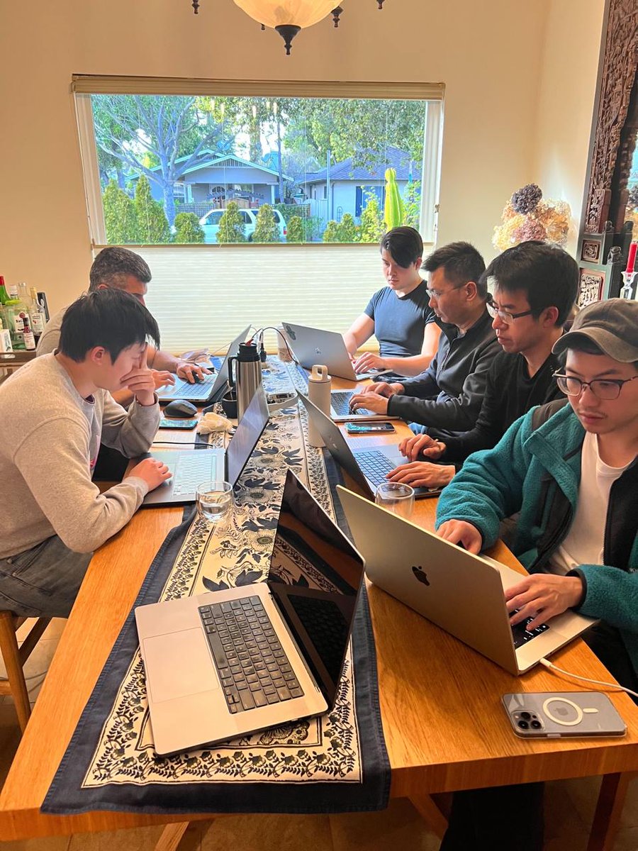 Story Protocol team working on laptops at a table