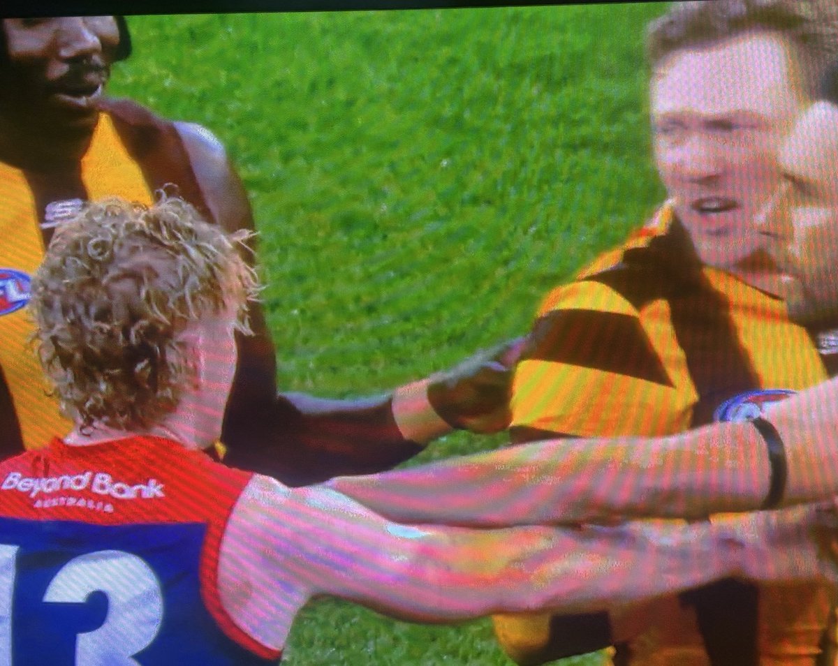 Clayton Oliver and James Sicily facing off at half time.