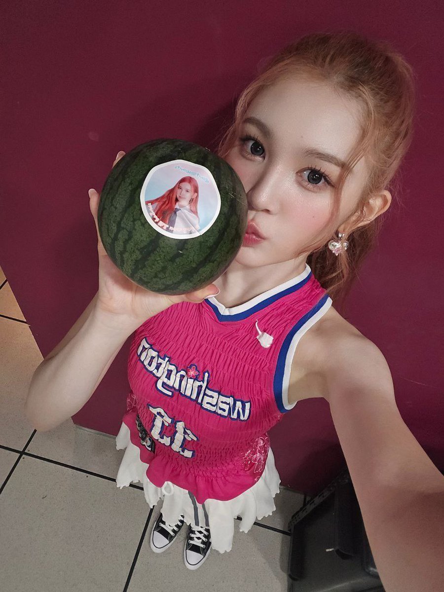 Rohaona's tweet photo. the vibrant purple backdrop sets a striking stage for her dazzling presence, her sleek pink jersey catching the light with its bold white and blue accents, a playful nod to sports culture woven into the aesthetic, confident pose with a peace sign. 💖 https://t.co/p5KbyhrbIg