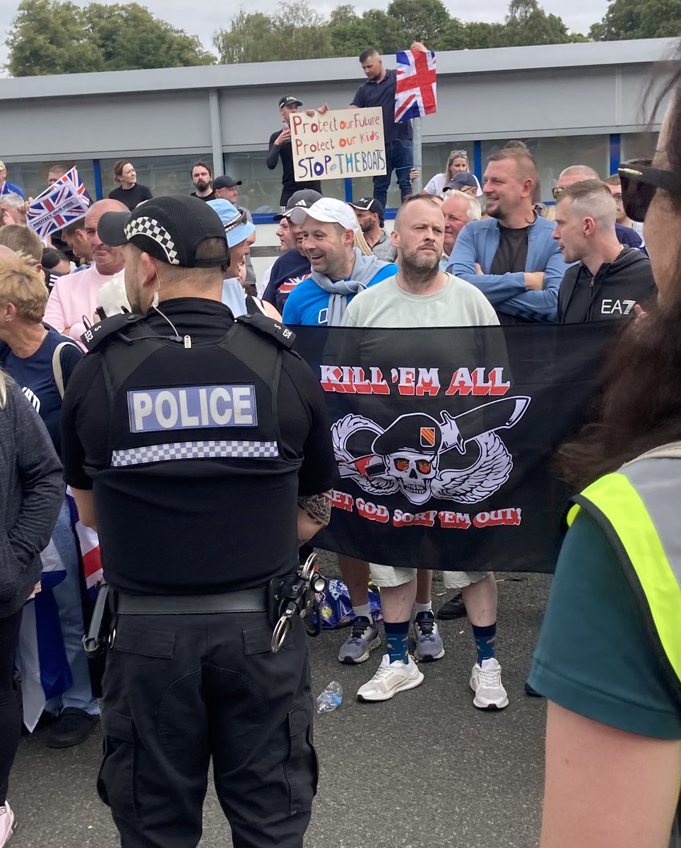 ‘Kill ‘em all! Let God sort ‘em out’ flag being held by the fascists and racists at the ‘peaceful’ far-right Save our Children demo. The mask has slipped with these ‘concerned residents’.