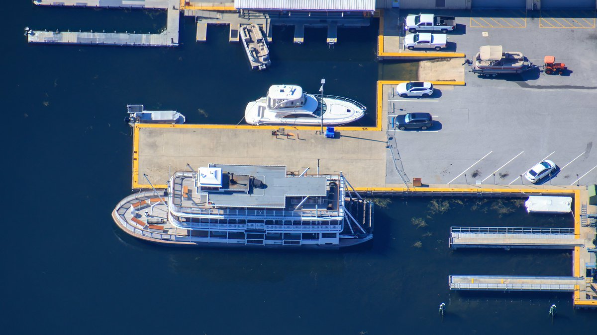 bioreconstruct's tweet image. Aerial photo of Liberty Belle riverboat at a dock in the Magic Kingdom resorts backstage marina.
