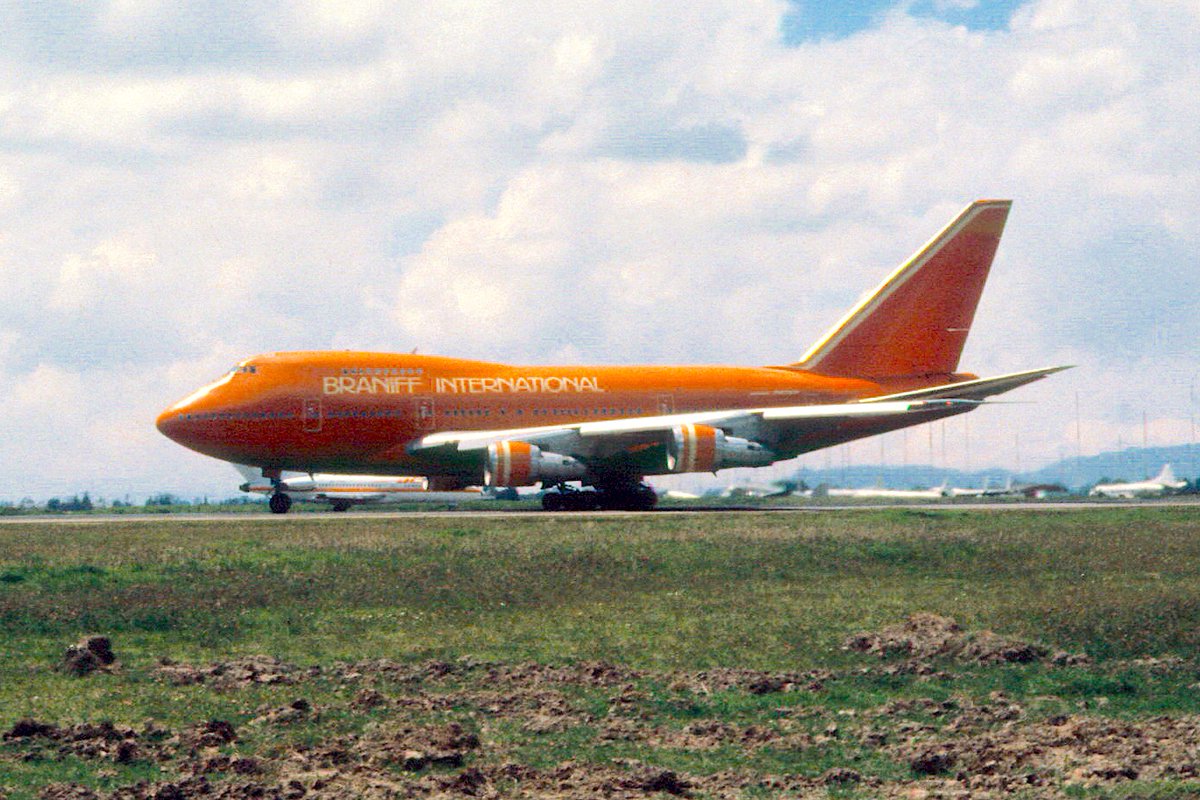 BRANIFF IN SOUTH AMERICA THE COLLECTION OF J. ESCOBAR - Braniff International Boeing 747SP-27 Ultra Space Jumbo Jet registered as N606BN is departing Bogota El Dorado Airport, in 1980. This big luxury liner is painted in the 1978 Harper and George/Cars and Concepts/Halston Little