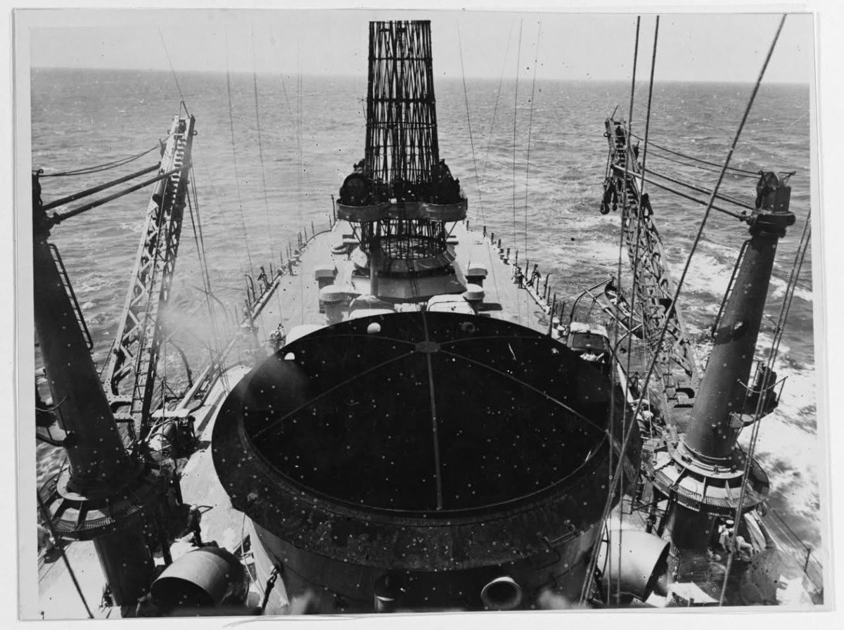 Aboard USS New Mexico in 1919, looking aft over her funnel top, past the boat cranes toward the cage mainmast. Naval History and Heritage Command photo.