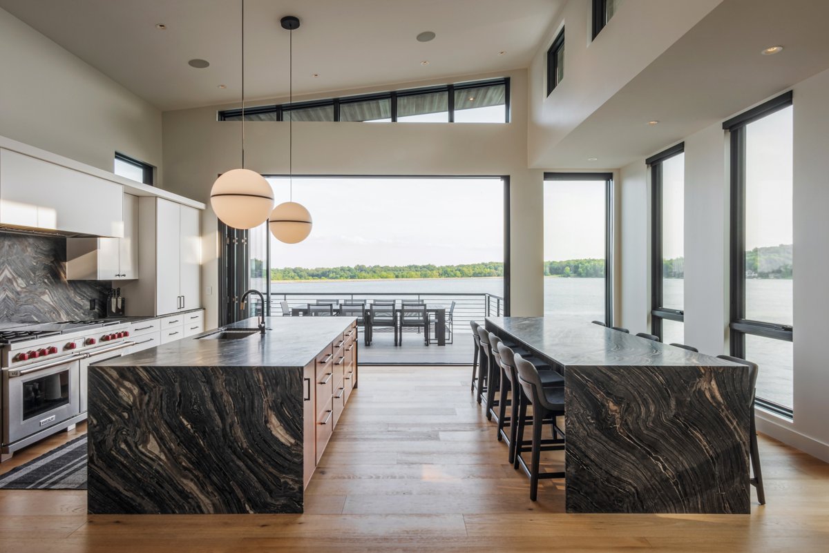 This home opens up to the water with a bi-fold door, topped with trapezoid direct sets that follow the roofline and flood the space with natural light. #BiFoldDoor

Photos by Adam Reynolds Photography
Inspired by Franklin Windows &amp; Doors and STILL Architecture + Design