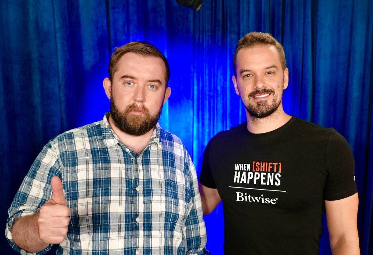 Sergey Nazarov and podcast host posing with thumbs up against a blue background