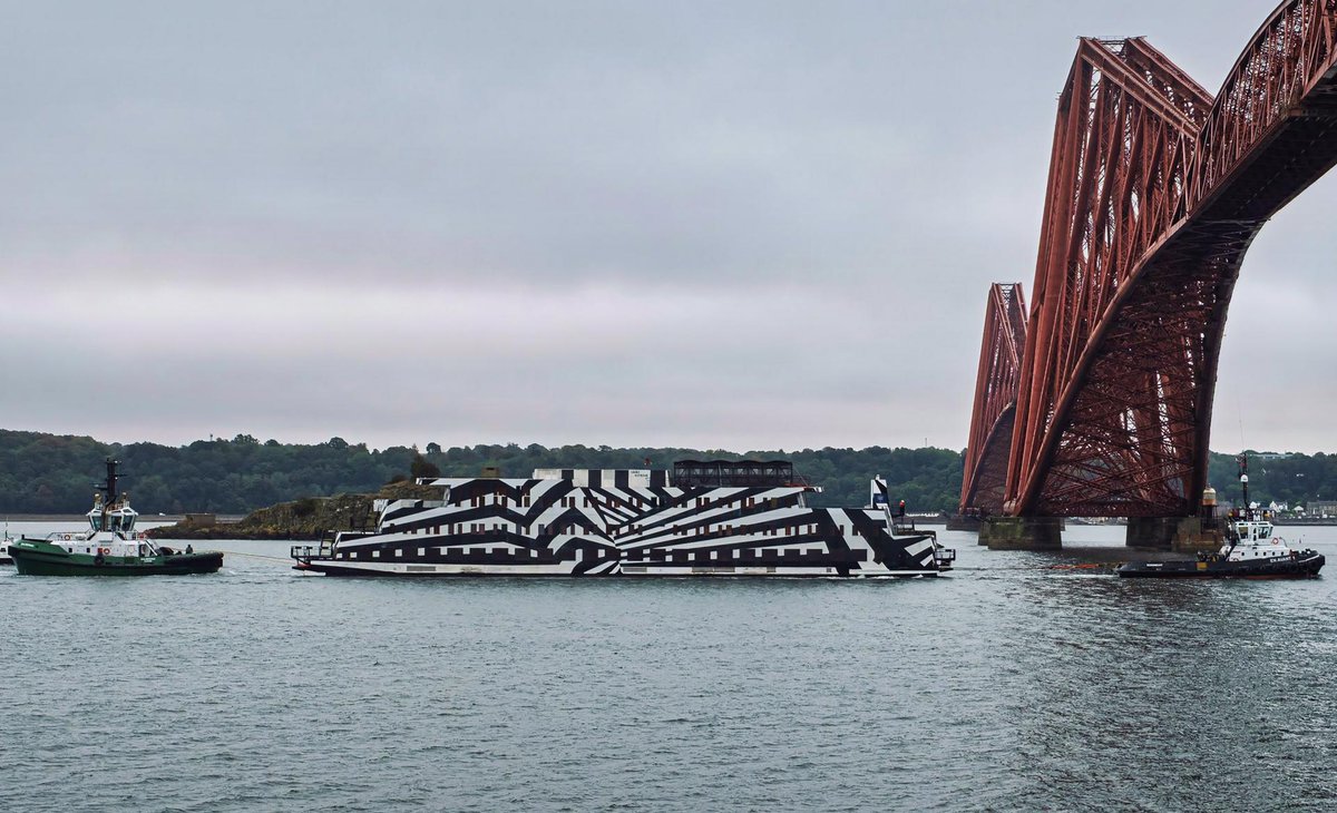 NavyLookout's tweet photo. Accommodation barge Sans Vitesse arriving at Rosyth this morning to house watch personnel from @HMSQNLZ while the carrier is in refit. 

Handily camouflaged against U-boat attack🙂 

Via @Brian_D2016