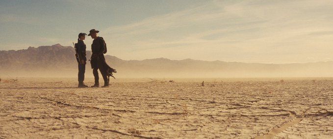 Lucy and Ghoul stand face to face in the Wasteland in a photo from Fallout Season Two
