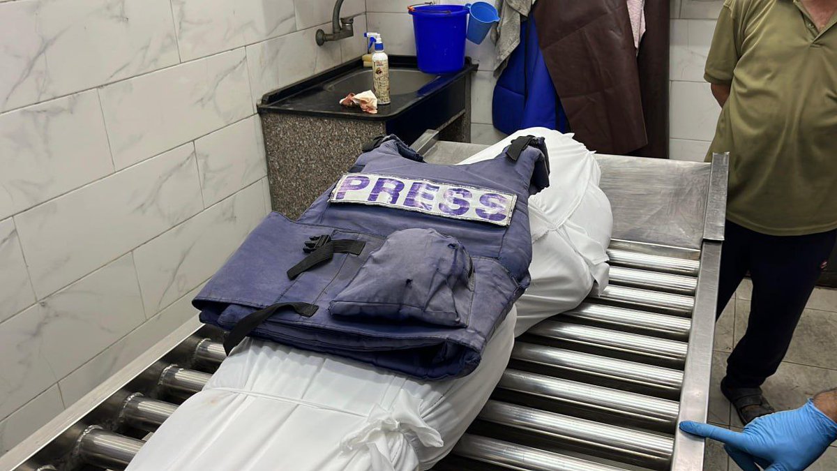 The body of journalist Islam Al-Koumi is being prepared for burial ceremony. He was killed last night along with his son in an Israeli airstrike in the Sabra neighborhood of Gaza City.