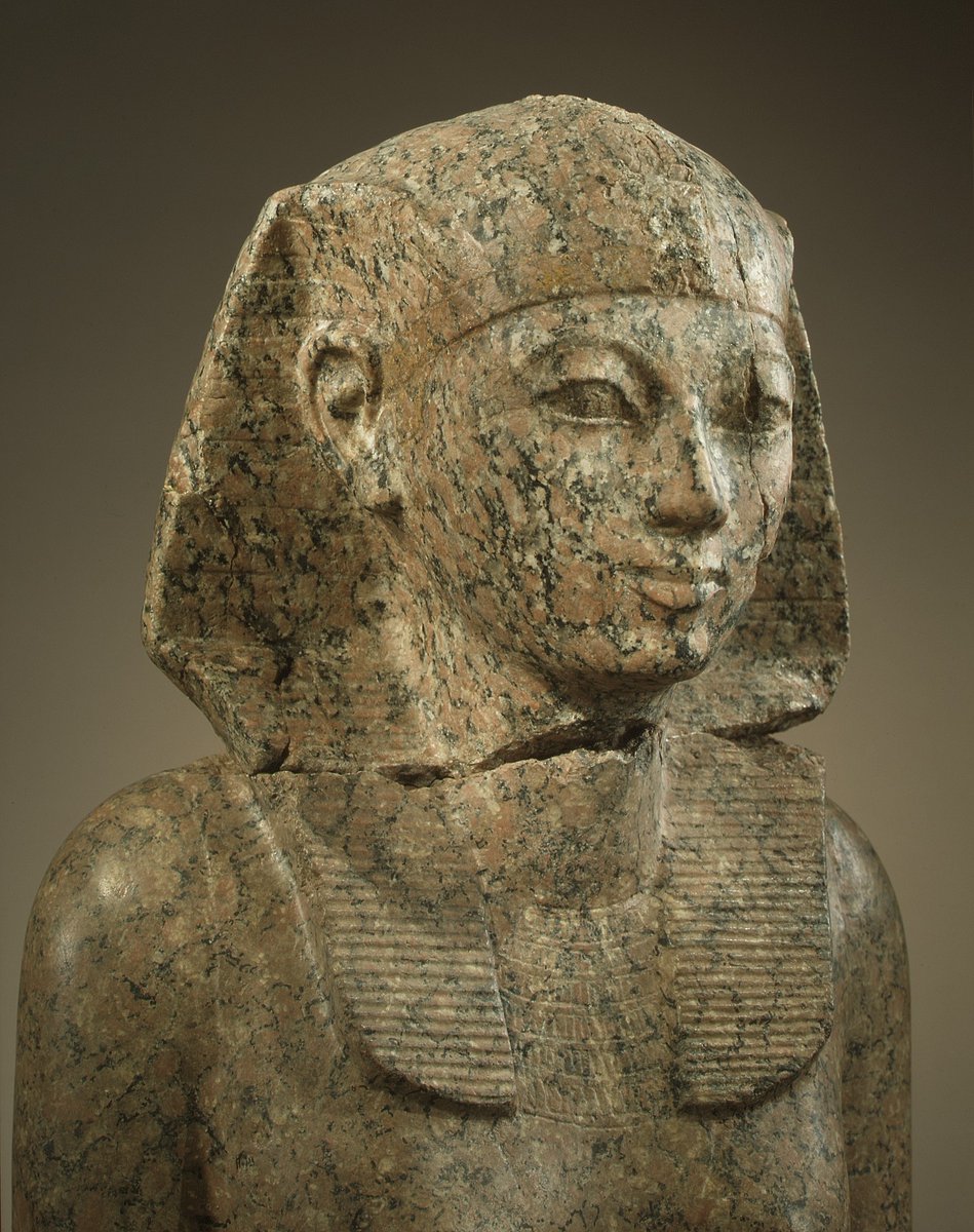 egyptomuseum's tweet photo. Statue of Hatshepsut

A life-sized granite statue of the female pharaoh Hatshepsut. The statue depicts her in a seated pose, wearing the nemes headdress and kilt, traditional attire for Egyptian kings, but also includes feminine titles and epithets.

Hatshepsut is portrayed as a king, wearing the royal nemes headdress and kilt, but with feminine attributes in the inscriptions.

While the statue features the throne name Ma'at-Ka-Re, #Hatshepsut's feminine titles, "Lady of the Two Lands" and "Bodily Daughter of Re," are also inscribed.

The statue reflects Hatshepsut's careful balance between her identity as a woman and her role as a ruler, as she adopted royal titles and attire while maintaining feminine distinctions.

New Kingdom, mid-18th Dynasty, joint reign of Hatshepsut and Thutmose III, ca. 1479-1458 BC.

Now in the Metropolitan Museum of Art. 29.3.3