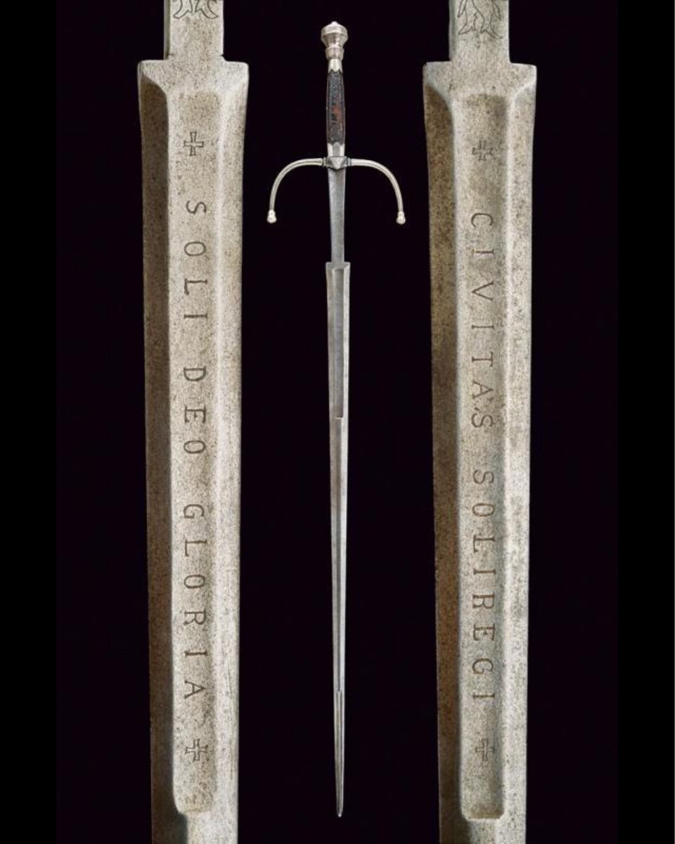 archaeologyart's tweet photo. Hand-and-a-half sword (estoc) with blade inscribed "CIVITAS SOLIREGI" and "SOLI DEO GLORIA". Culture: Italian, North Italy; mid–16th century AD; steel/iron with silver fittings, wood grip with traces of leather; length 127 cm. Collection: Czerny’s International Auction House.

Inscriptions: 

CIVITAS SOLI REGI → “The commonwealth (city/state) is for the one King.”
SOLI DEO GLORIA → “Glory to God alone.”