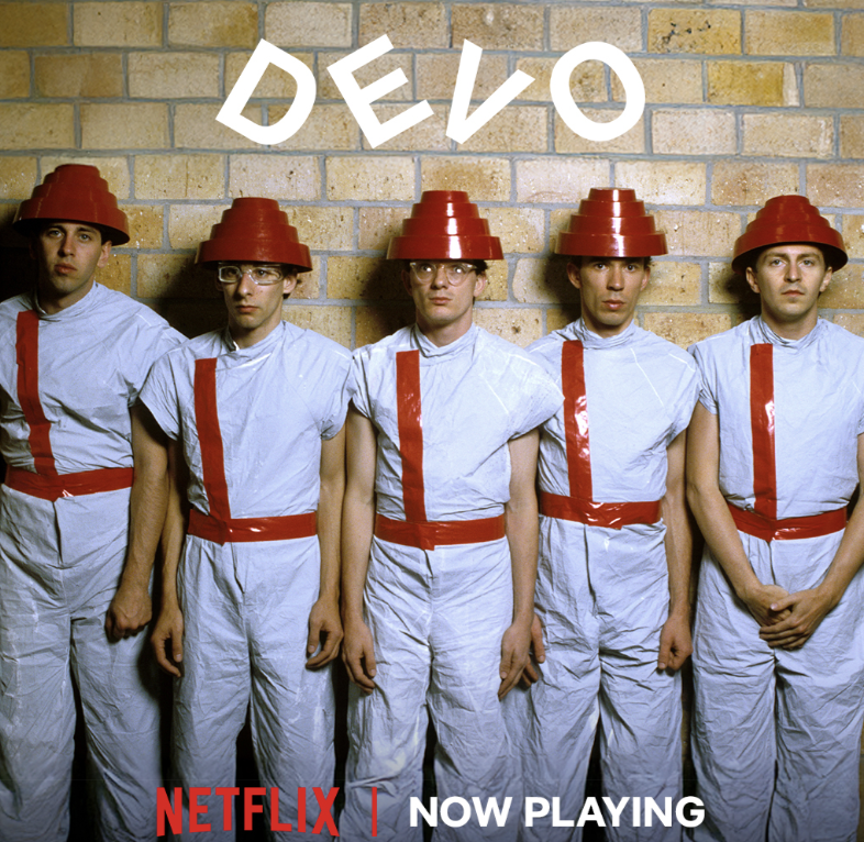 DEVO's tweet photo. Attn. Spuds, Netflix just got more devolved. Chris Smith’s DEVO documentary is streaming now.

Pre-order the companion release Energy Dome Frequencies: Songs from the DEVO Documentary at https://t.co/8lQUenQgjc (link in bio). Available on red vinyl, CD, t-shirt, and bundles. https://t.co/UUrYXnbi30
