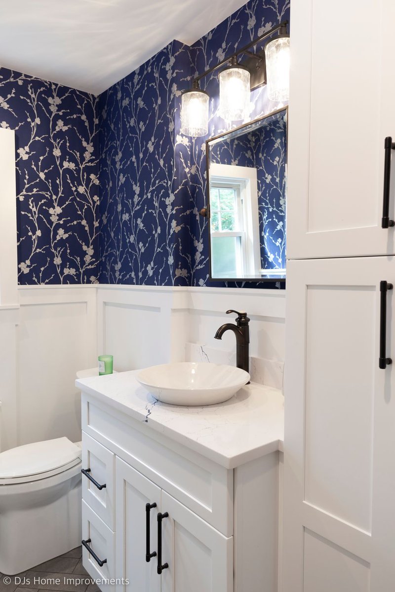 djshomeimprove's tweet photo. This powder room remodel blends timeless details with bold blue accents for a sophisticated finish. The lower wall paneling is painted in @Benjamin Moore Paper White, creating a crisp base, while the upper walls feature a blue wallpaper that ties together the room’s rich blues. https://t.co/4TNxyiaScK