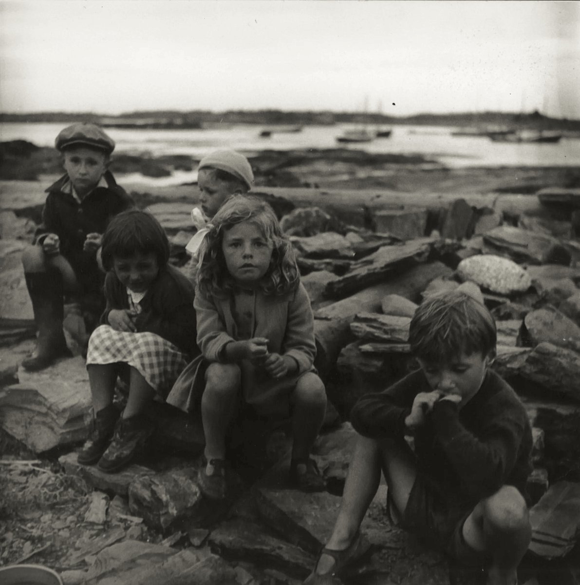 Children sitting on rocks at port, New York City, ca. 1940 - by Sandra Weiner (1921 - 2014), Polish/American