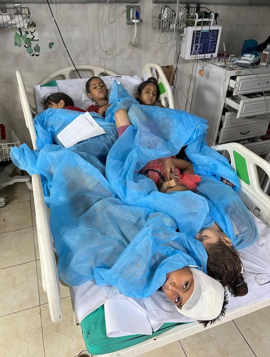 6 children sharing a single bed in a hospital in Gaza Strip.