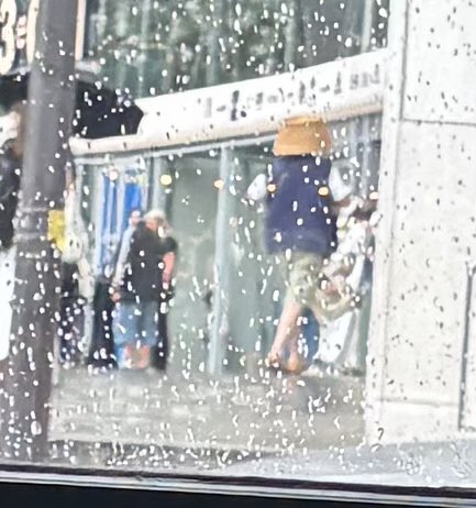 Paris being the hub of fashion that it is, this guy is displaying the latest trend for inclement weather, the wicker basket!
