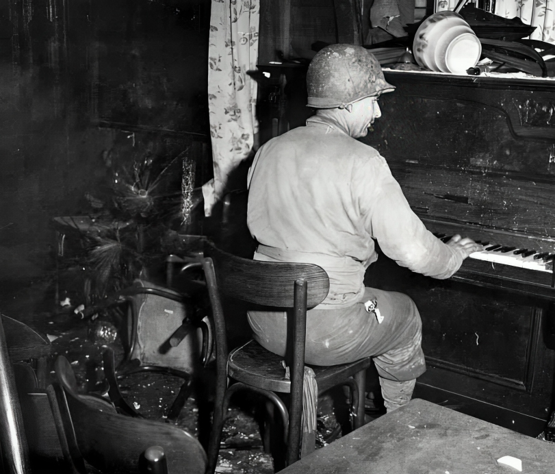 October 8, 1944. A Helena soldier sits at a weathered piano in a bombed-out German beer hall. His worn hands, more used to holding a rifle, bring a gentle melody to life amid the wreckage of war.

That soldier was Private First Class Richard LaRock, and this photograph was taken