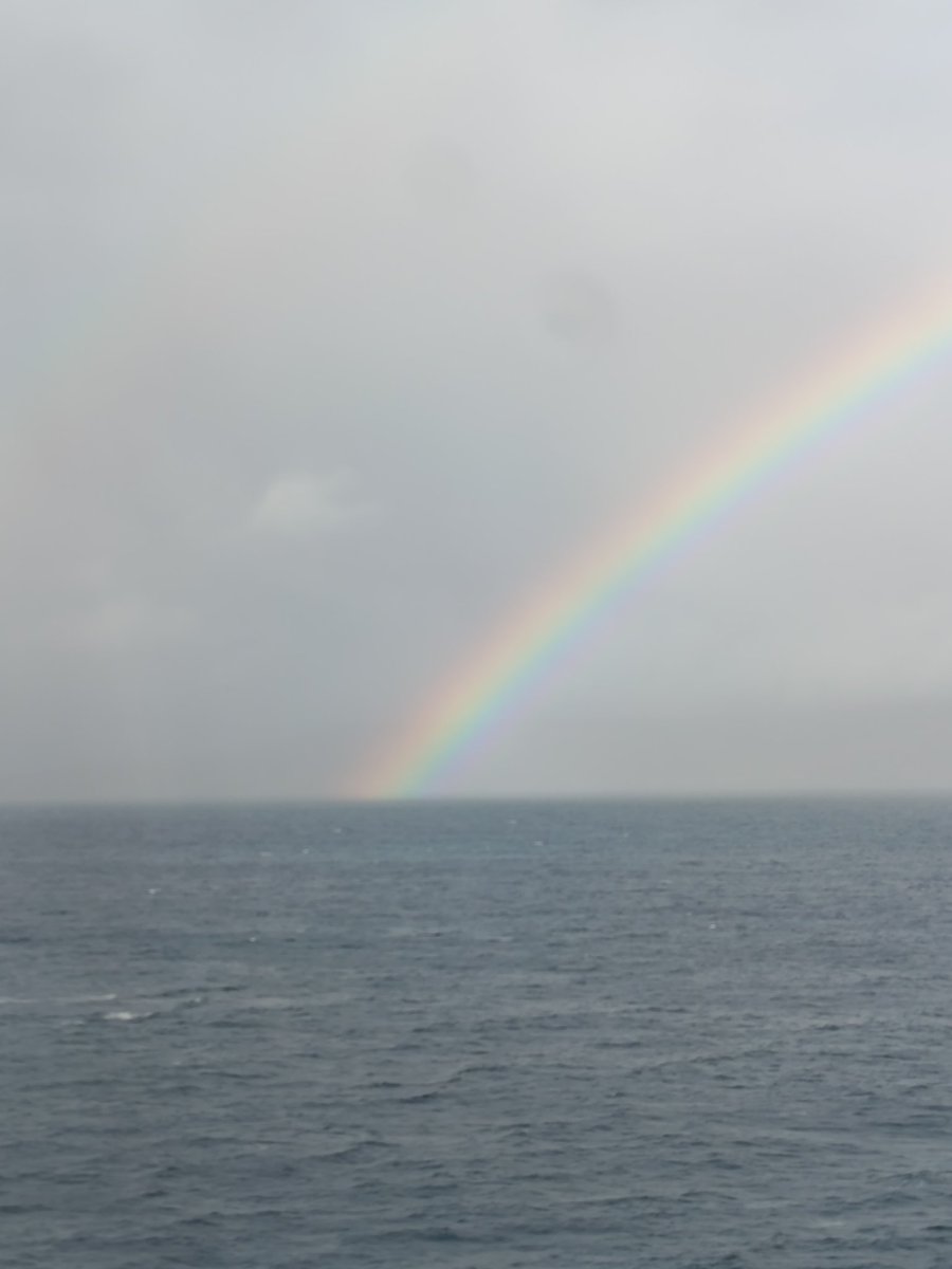 Fingal's Rainbow 🌈 with one of the Hebrides Islands in the moody background. Sunshine, showers and cloud, punctuating the sky with dramatic colour changes and fabulous rainbows