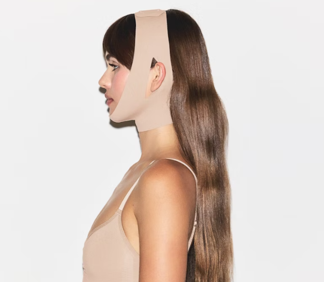 Shapewear and athleisure clothing brand <a href="/skims/">SKIMS</a> has developed a seamless face wrap which is said to sculpt the face and provide targeted compression. For more information, visit bit.ly/3I1Qzz5 #skims #shapewear