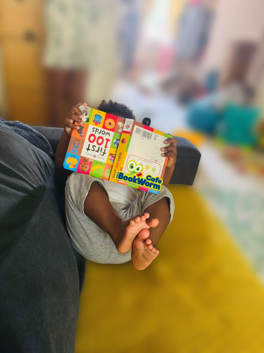 Baby reading is REAL reading! 😀 Upside down, backwards, or made-up stories, kids are exploring books their way.   📖 #EarlyLiteracy #TheBookwormCafe