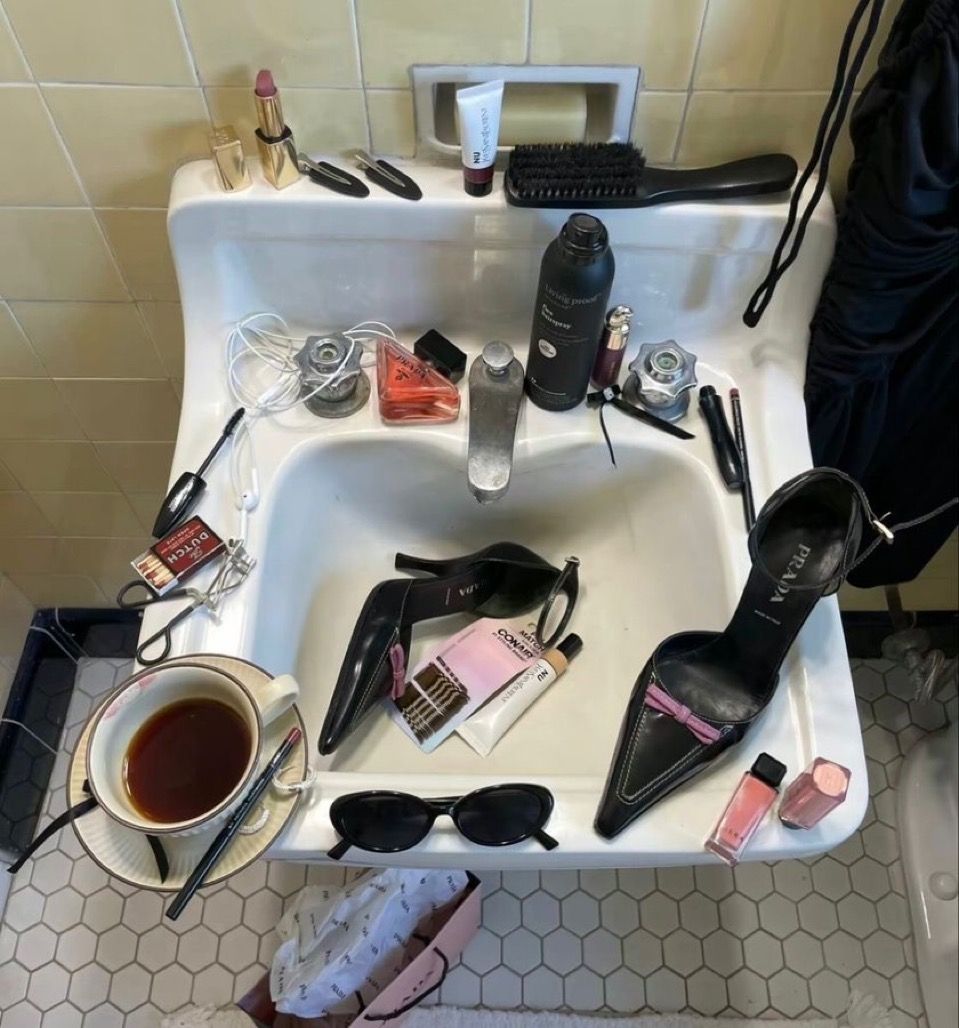 laceandstatic's tweet photo. Prada heels in the sink, makeup, &amp; tea says everything: it’s chaos, but it’s curated. That’s my brand. I don’t separate glamour from mess I like when they overlap. This image shows that identity for me way better than something “perfect” ever could.#MCO335 https://t.co/5NF2JkFxjJ