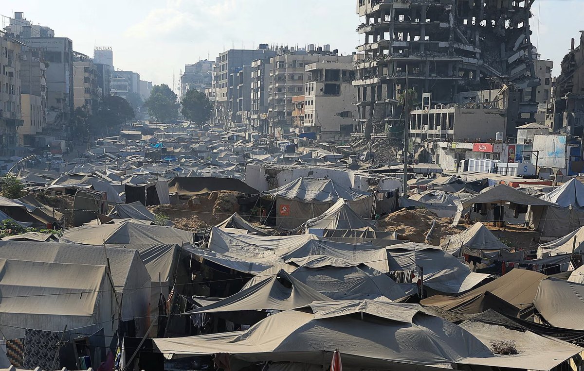 Displaced Palestinians shelter in a tent camp as the Occupation army intensifies its assault around Gaza City.