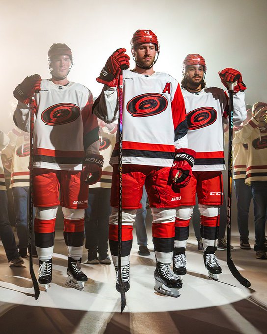 Photo of Jaccob Slavin, Jalen Chatfield, and Andrei Svechnikov modeling the Canes new away uniforms 